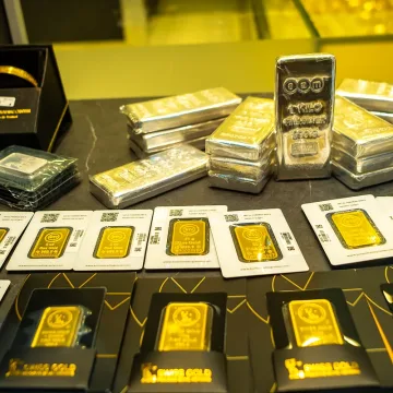 Gold-coins-and-bars.webp Evaluating Gold Transport Costs: UAE to India Comparison
